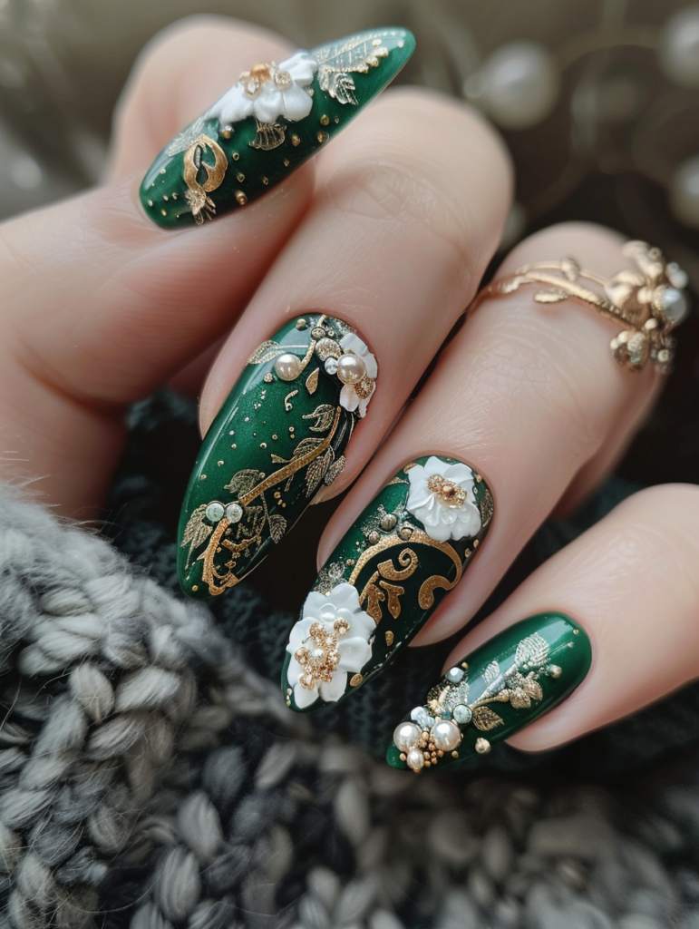 Full view of both hands showcasing emerald green & gold Victorian floral nail art on long almond nails, featuring blooming white and gold flowers, swirling gold vines, pearl accents, and delicate metallic details