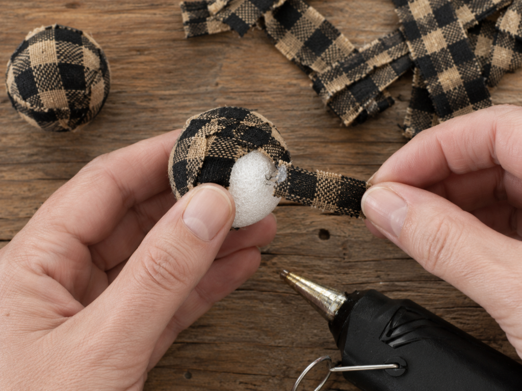 Covering a small foam ball with homespun fabric strips