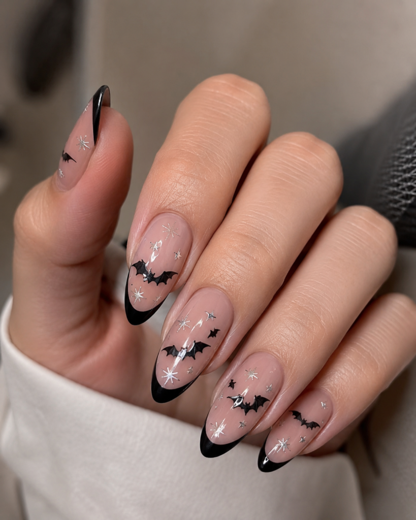 Black bat French tip nails with a nude base for Halloween