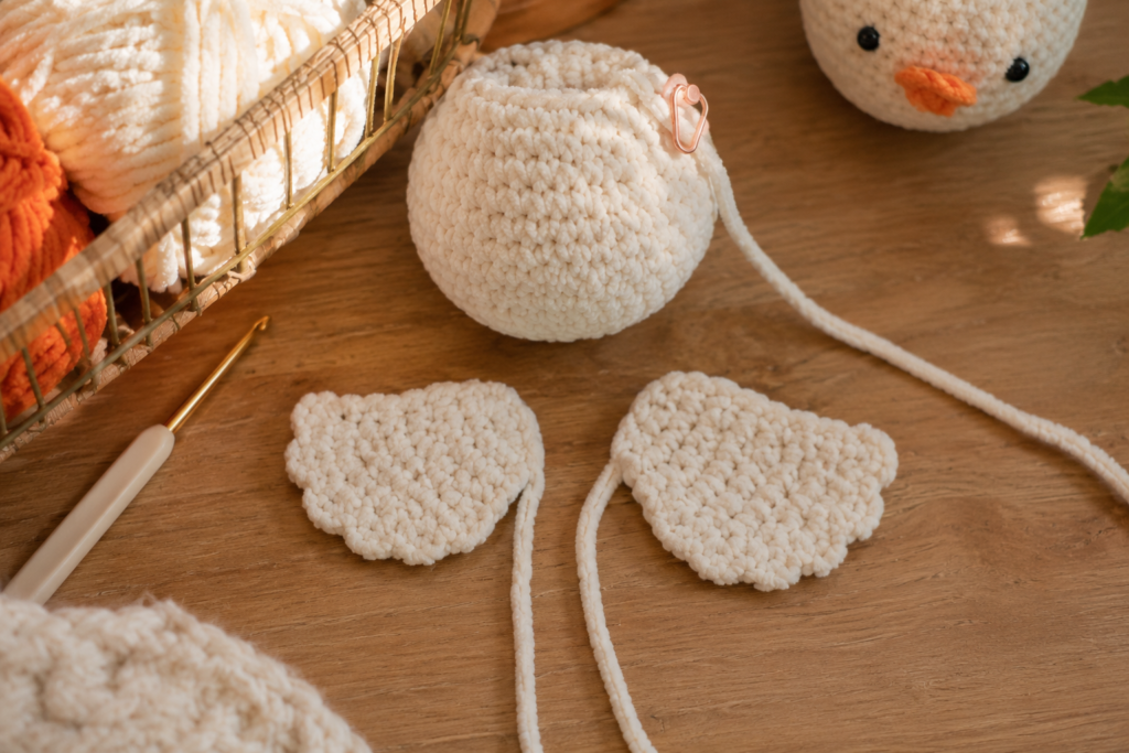 Two handmade crochet wings for a lying duck amigurumi