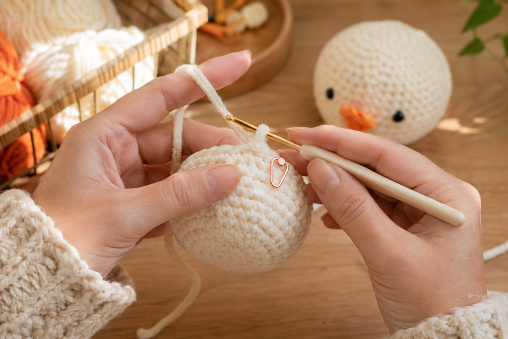 Crocheting the rounded head of a lying duck amigurumi